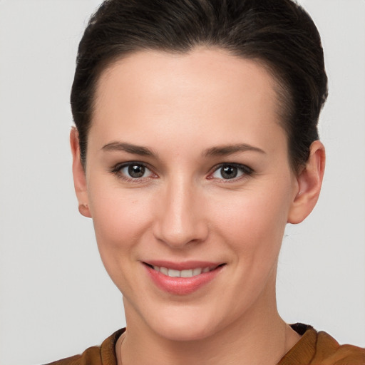 Joyful white young-adult female with short  brown hair and brown eyes