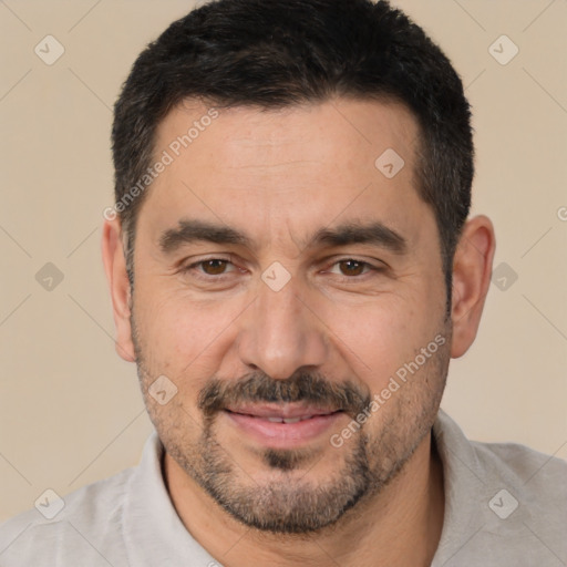 Joyful white adult male with short  black hair and brown eyes