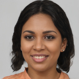 Joyful latino young-adult female with medium  brown hair and brown eyes