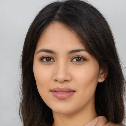 Joyful latino young-adult female with long  brown hair and brown eyes