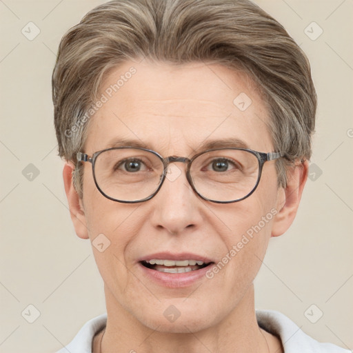 Joyful white adult male with short  brown hair and grey eyes