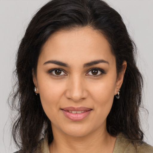 Joyful latino young-adult female with long  brown hair and brown eyes
