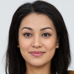 Joyful asian young-adult female with long  brown hair and brown eyes