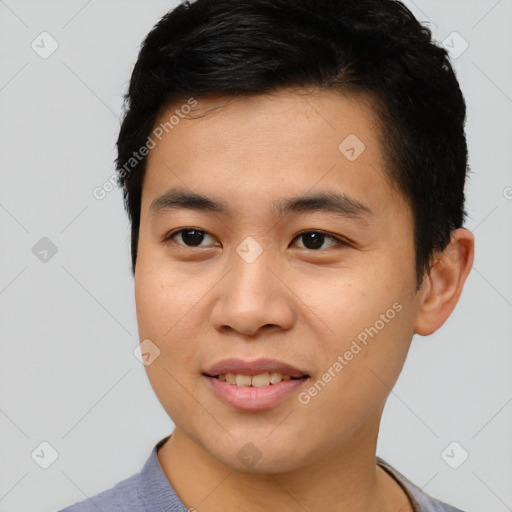 Joyful asian young-adult male with short  brown hair and brown eyes