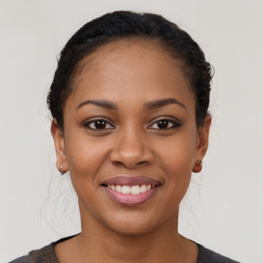 Joyful black young-adult female with short  brown hair and brown eyes