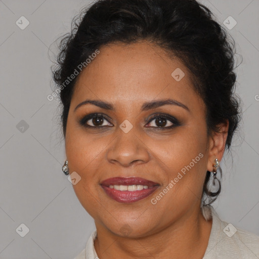 Joyful black adult female with medium  brown hair and brown eyes