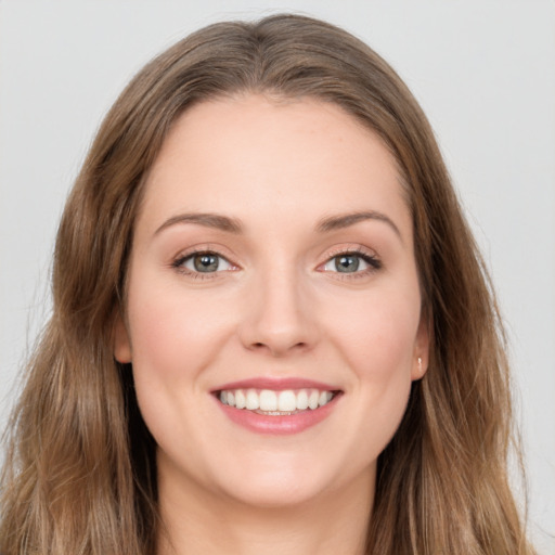 Joyful white young-adult female with long  brown hair and green eyes