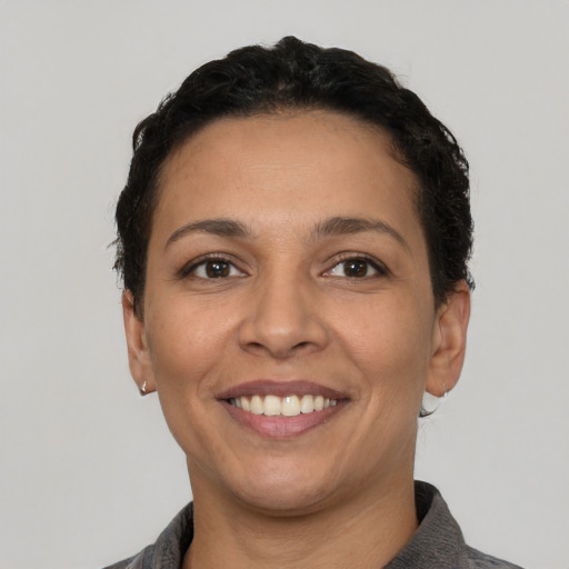 Joyful white young-adult female with short  black hair and brown eyes