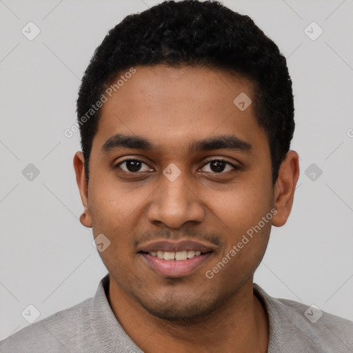 Joyful black young-adult male with short  black hair and brown eyes
