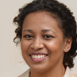 Joyful black young-adult female with medium  brown hair and brown eyes