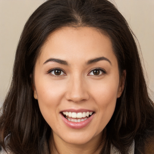 Joyful white young-adult female with long  brown hair and brown eyes