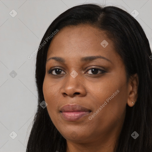 Joyful black young-adult female with long  black hair and brown eyes