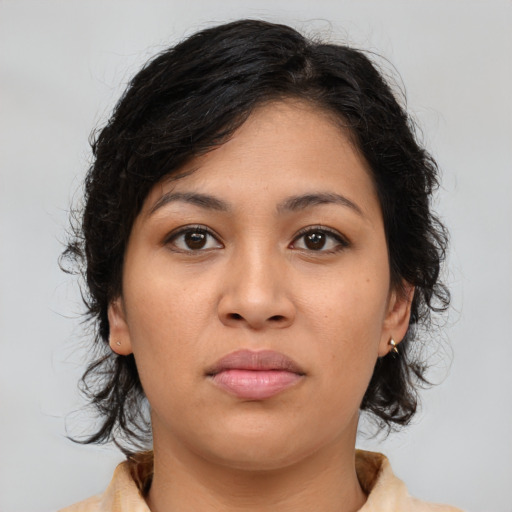 Joyful latino young-adult female with medium  brown hair and brown eyes