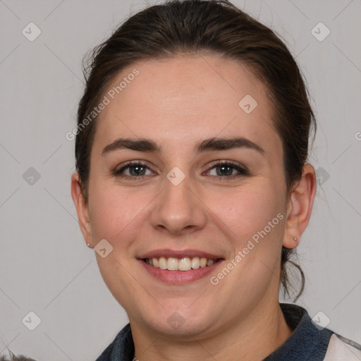 Joyful white young-adult female with medium  brown hair and grey eyes