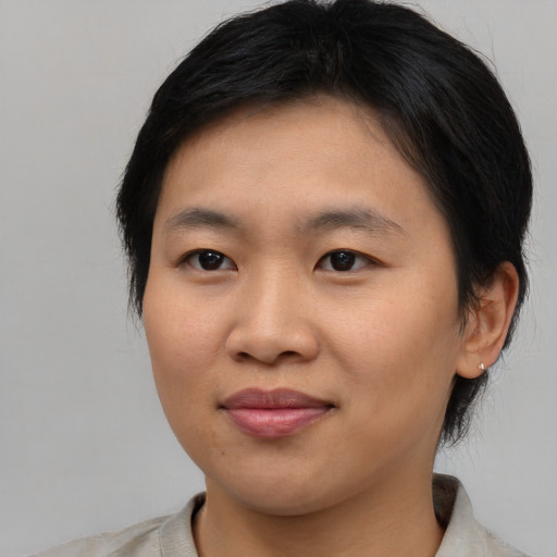 Joyful asian young-adult female with medium  brown hair and brown eyes