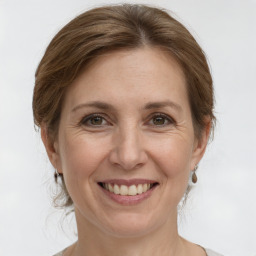 Joyful white adult female with medium  brown hair and grey eyes