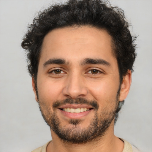 Joyful latino young-adult male with short  black hair and brown eyes