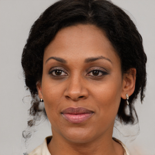 Joyful black young-adult female with medium  brown hair and brown eyes