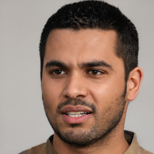 Joyful latino young-adult male with short  black hair and brown eyes