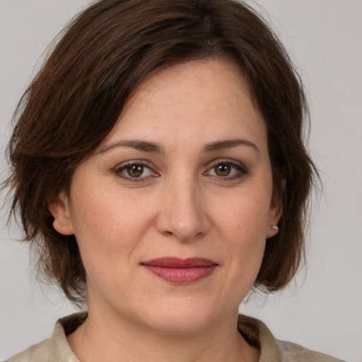 Joyful white adult female with medium  brown hair and brown eyes