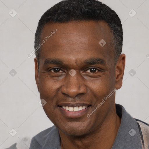 Joyful black adult male with short  black hair and brown eyes