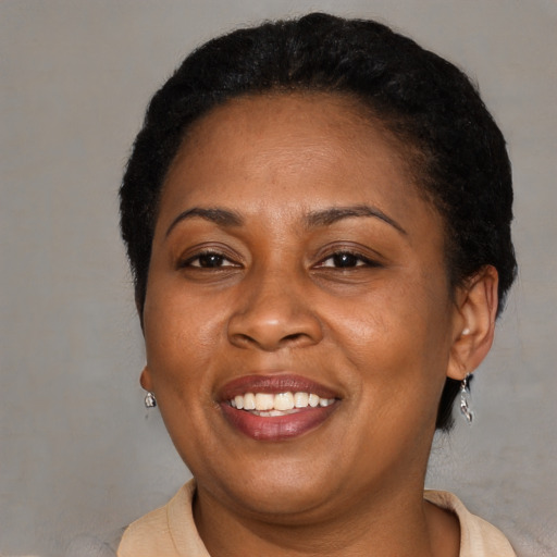 Joyful latino adult female with short  brown hair and brown eyes