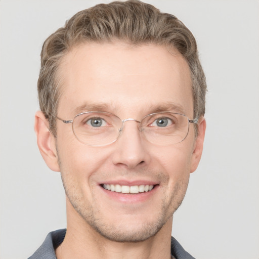 Joyful white adult male with short  brown hair and grey eyes