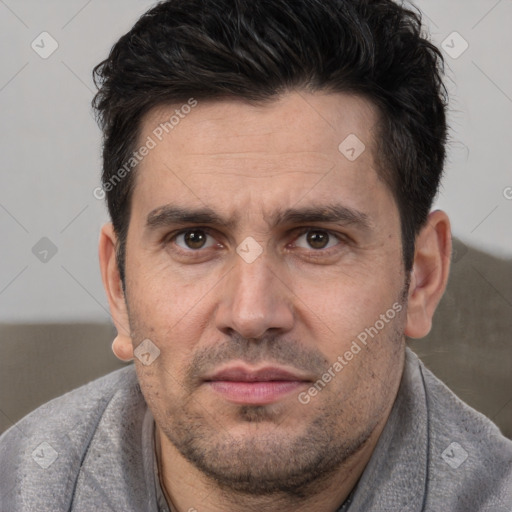 Joyful white adult male with short  brown hair and brown eyes