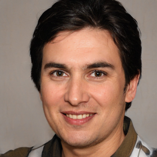 Joyful white adult male with medium  brown hair and brown eyes