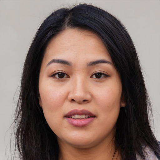 Joyful asian young-adult female with long  black hair and brown eyes