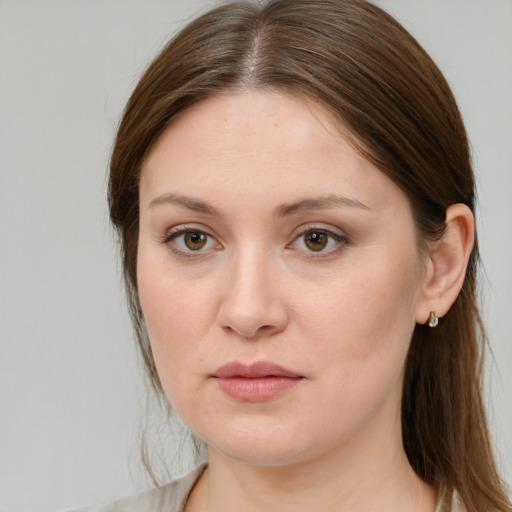 Joyful white young-adult female with medium  brown hair and grey eyes