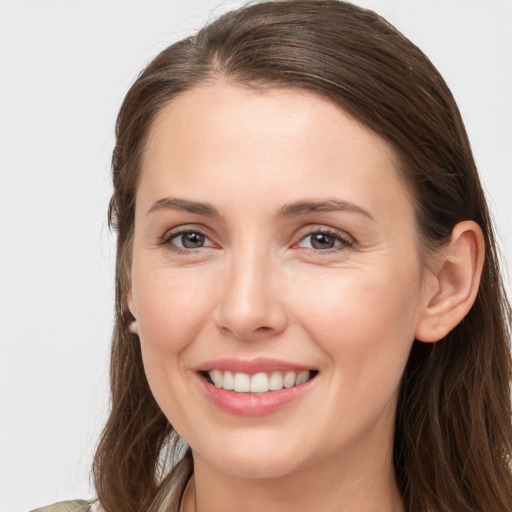 Joyful white young-adult female with long  brown hair and grey eyes