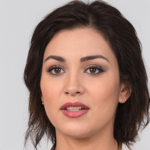 Joyful white young-adult female with medium  brown hair and brown eyes