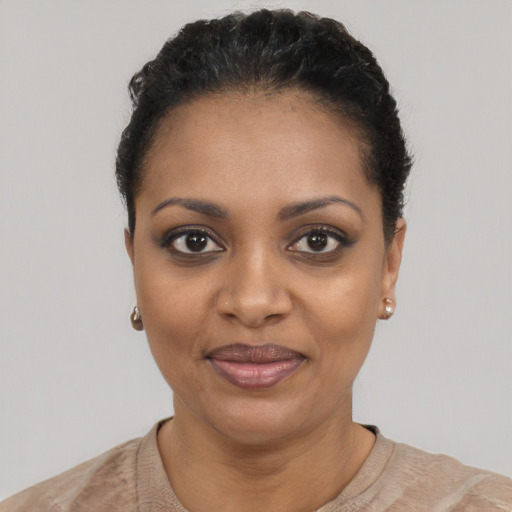 Joyful black young-adult female with short  black hair and brown eyes