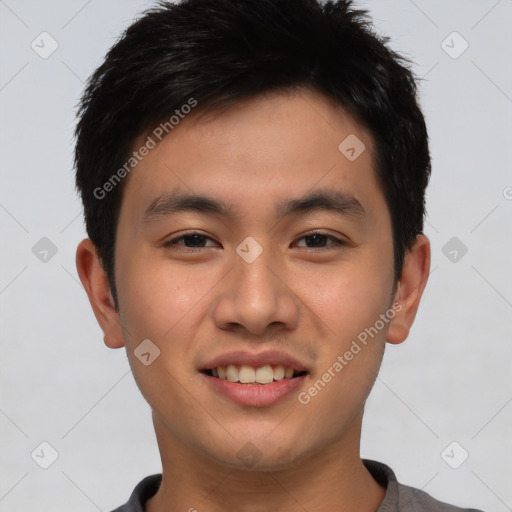 Joyful asian young-adult male with short  brown hair and brown eyes