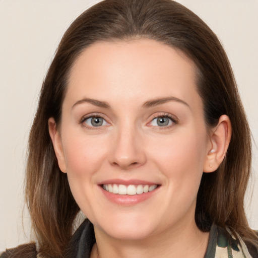 Joyful white young-adult female with long  brown hair and grey eyes