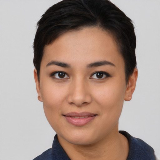 Joyful asian young-adult female with short  black hair and brown eyes