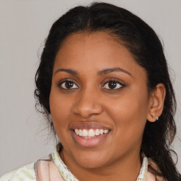 Joyful latino young-adult female with medium  brown hair and brown eyes