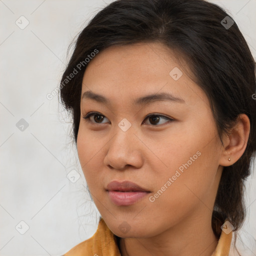 Joyful asian young-adult female with long  brown hair and brown eyes