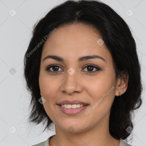 Joyful latino young-adult female with medium  brown hair and brown eyes