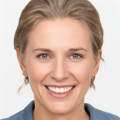 Joyful white adult female with medium  brown hair and grey eyes