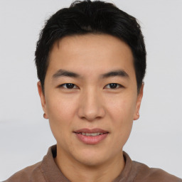 Joyful asian young-adult male with short  black hair and brown eyes