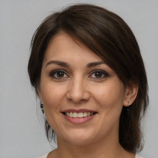 Joyful white young-adult female with medium  brown hair and brown eyes