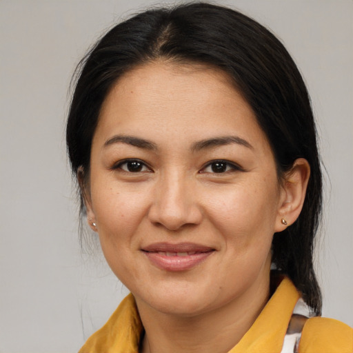 Joyful asian young-adult female with medium  brown hair and brown eyes
