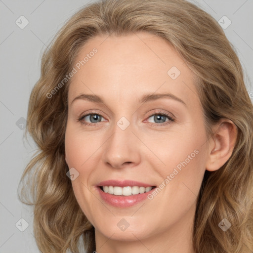 Joyful white adult female with medium  brown hair and blue eyes