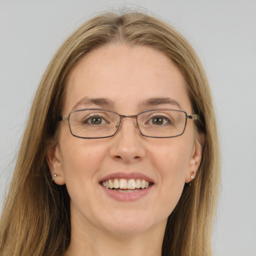 Joyful white young-adult female with long  brown hair and green eyes