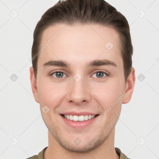 Joyful white young-adult male with short  brown hair and grey eyes