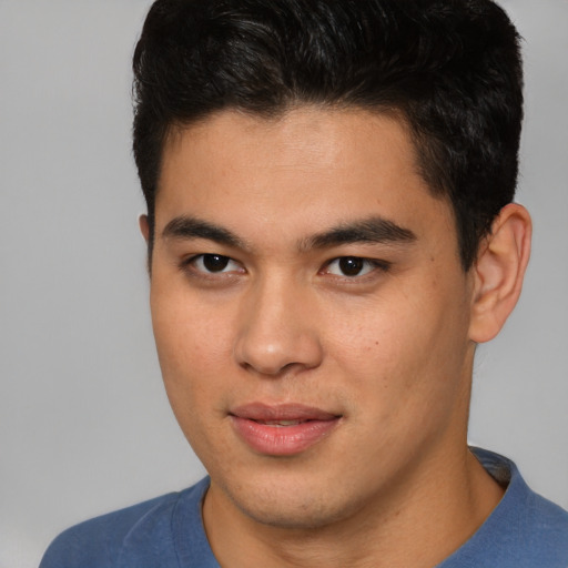 Joyful asian young-adult male with short  brown hair and brown eyes