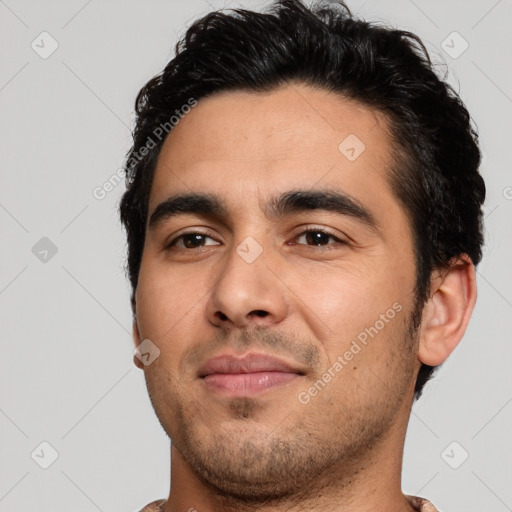 Joyful white young-adult male with short  black hair and brown eyes