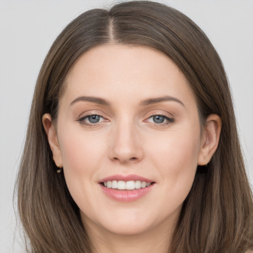 Joyful white young-adult female with long  brown hair and grey eyes